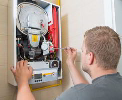 Image showing a man preforming a boiler repair